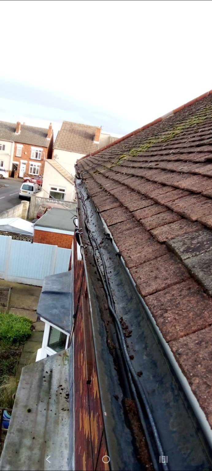 Roof gutter cleared after debris removal by RMS
