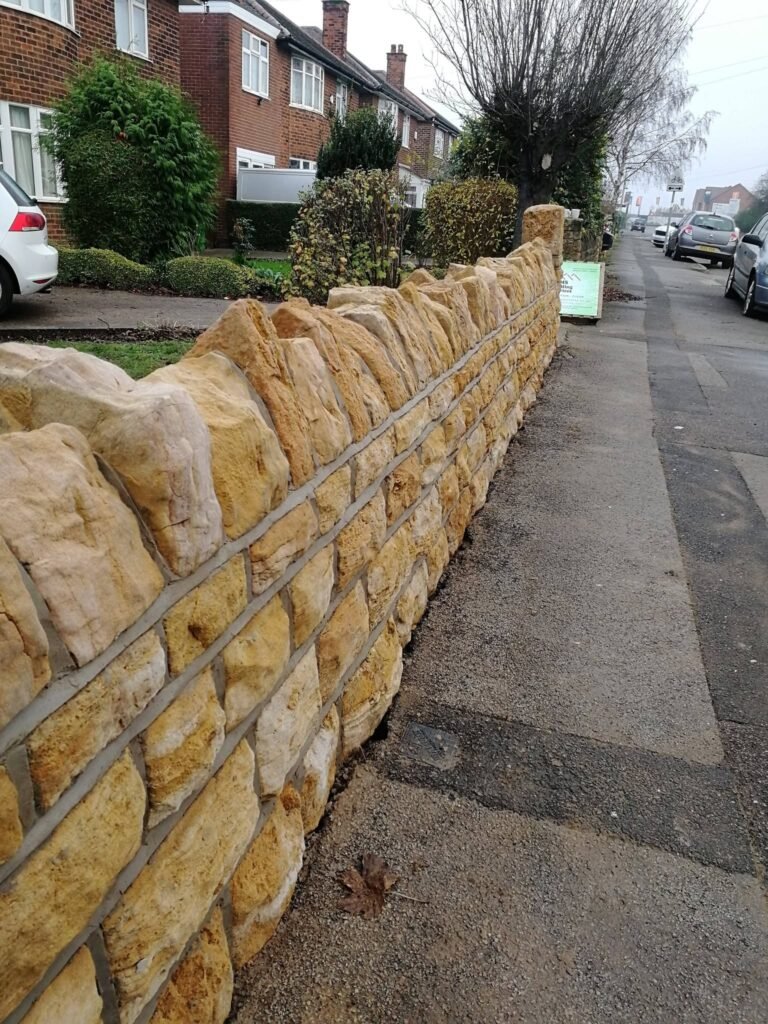 Cleaned and repointed stone wall restored by RMS in Aspley